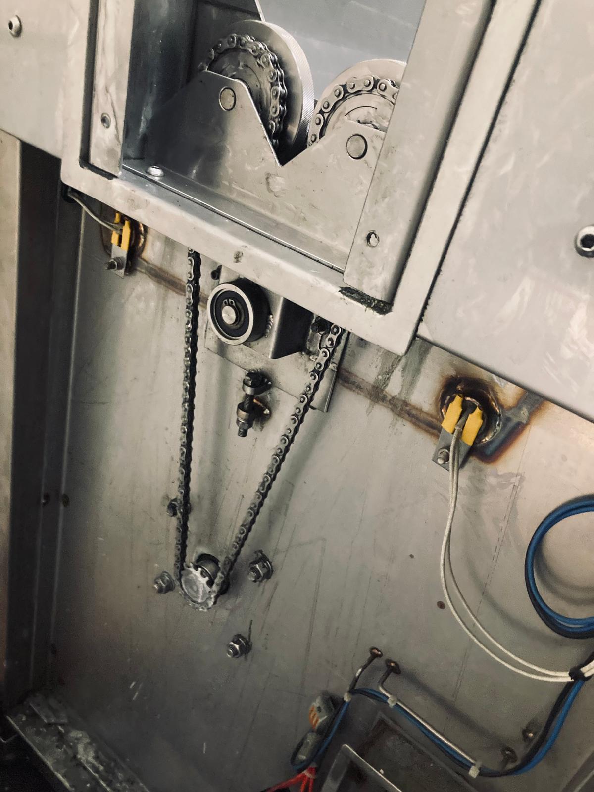 Drive and chain components inside an ultrasonic cleaning system